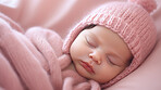 Closeup of sleeping newborn girl baby. Portrait of baby wrapped in blanket