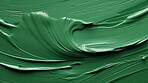 Green smooth paint texture close-up. Swirl abstract background.