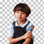 Portrait of a little asian boy holding his arm and showing his bandaid. Child wearing a plaster after being forced to get the vaccine, sad kid after getting an injection against an orange background