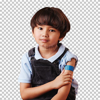 Portrait of a little asian boy holding his arm and showing his bandaid. Child wearing a plaster after being forced to get the vaccine, sad kid after getting an injection against an orange background