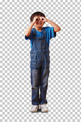 Curious little boy looking through fingers shaped like binoculars while wearing casual clothes against a yellow studio background