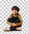 A cute little asian boy sitting on the floor with casual clothes while laughing and crossing his legs against an orange copyspace  background. Adorable happy little boy safe and alone