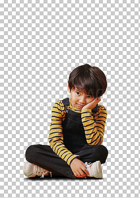 One asian boy looking sad and depressed while sitting on the floor and posing against orange copyspace background. Cute mixed race child with ADD looking bored and depressed