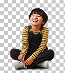 A cute little asian boy sitting on the floor with casual clothes while laughing and crossing his legs against an orange copyspace  background. Adorable happy little boy safe and alone