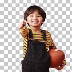 Cute little mixed race boy smiling and pointing while holding a football and posing against an orange copyspace background