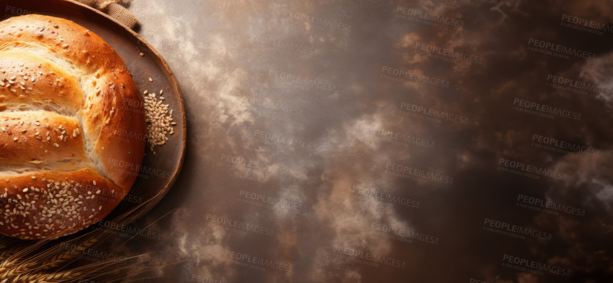 Buy stock photo Top view of freshly baked loaf of bread with grain on table with copy space.