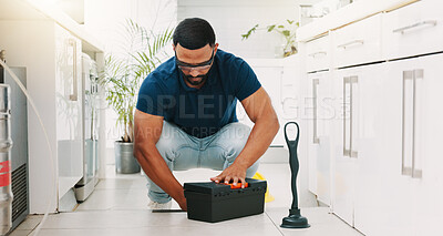 Plumber man, tools and box on floor maintenance with packing, focus and pipe repair service in house. Entrepreneur handyman, plumbing expert and small business owner with toolbox in home kitchen
