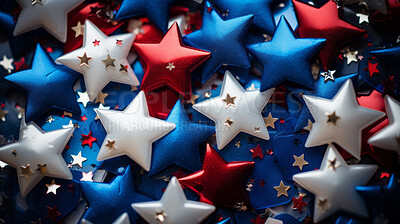 Close-up of decorative confetti in the shape of stars. Coloured with American flag colours.