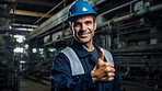 Confident mature older man with hardhat in shipping warehouse showing thumbsup at camera