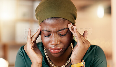 Headache, stress and burnout with a business black woman suffering from tension while working in her office. Anxiety, mental health and pain with a female employee rubbing her temples in discomfort