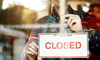 Buy stock photo Closeup shot of an unrecognizable man hanging up an open sign in a shop window