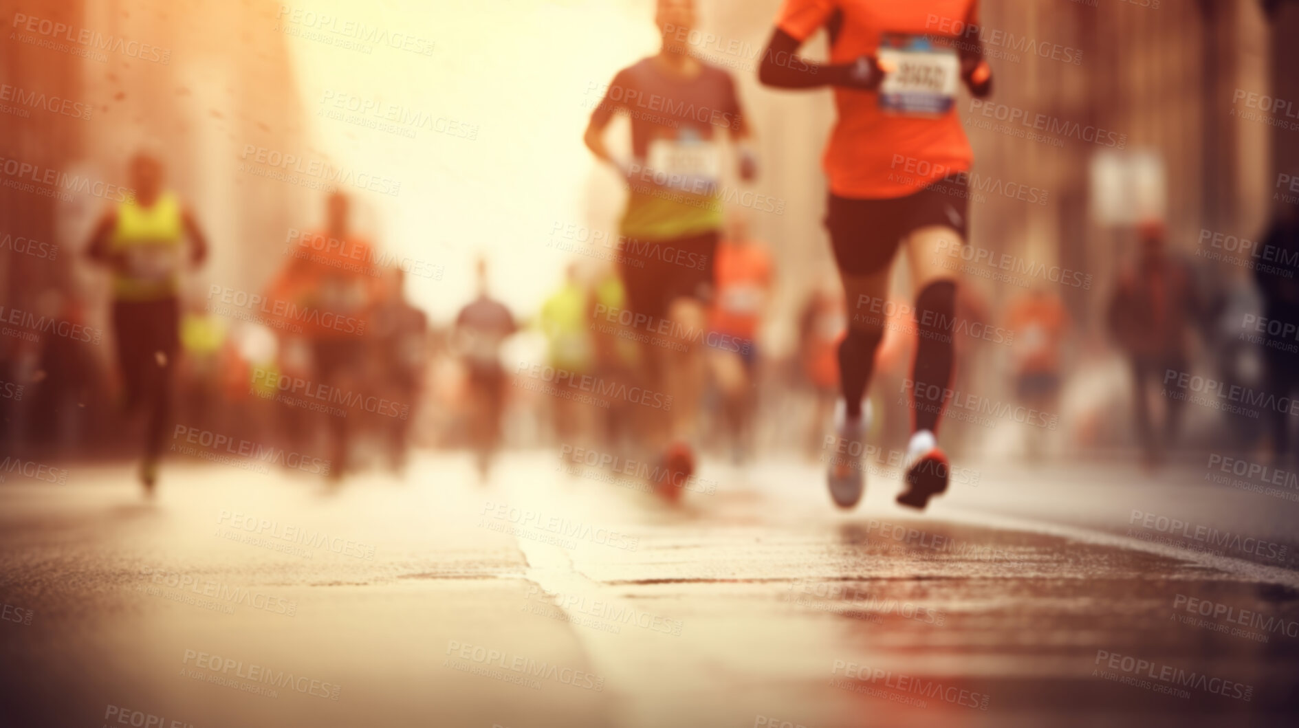 Buy stock photo Group of marathon runners in the city. Low angle view of runners in competition