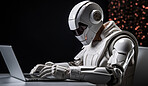 Male Cyborg, robot sitting at table working on laptop. Futuristic human technology concept.