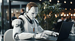 Male Cyborg, robot sitting at restaurant table working on laptop. Futuristic human technology concept.