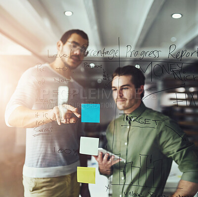 Buy stock photo Cropped shot of two young designers planning on a glass board