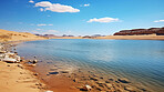 Crystal clear lake in desert area. Sand hills and blue sky. Oasis, tourism concept.