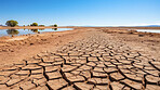 Dried up lake in desert area. Dry cracked soil. Global warming concept.