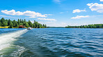 Point of view  shot of  boat trail on crystal clear lake. Vacation, summer, travel