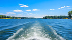 Point of view  shot of  boat trail on crystal clear lake. Vacation, summer, travel