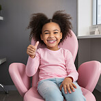 Child at the dentist office. Happy school aged child giving thumbsup in dentist chair. Healthcare concept