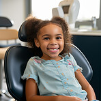 Child at the dentist office. Happy school aged child sitting on dentist chair. Healthcare concept