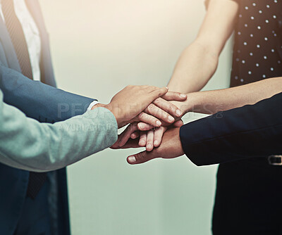 Buy stock photo Cropped shot of a group of unrecognisable businesspeople joining their hands together in unity
