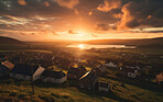 Sunrising on small European town on hillside, covered in mist. Golden hour concept