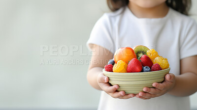 Toddler holding fresh fruit bowl. Healthy food. Vitamins and healthy.