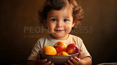 Toddler holding fresh fruit bowl. Healthy food. Vitamins and healthy.