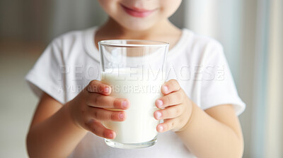 Buy stock photo Toddler holding a glass of milk. close-up of baby with a glass of milk