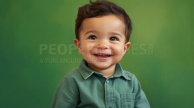 Buy stock photo Portrait of a toddler posing against a green background. happy smiling boy