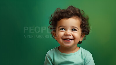 Buy stock photo Portrait of a toddler posing against a green background. happy smiling girl