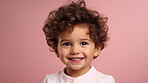 Portrait of a toddler posing against a pink background. happy smiling boy