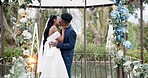 Wedding, dance and kiss, black couple in garden with love, celebration and excited for future together. Gazebo, man and woman at marriage reception with flowers, music and happiness at outdoor party