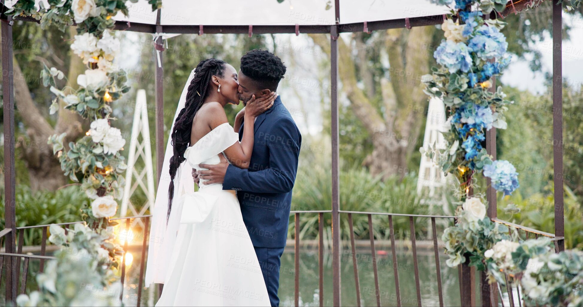 Buy stock photo Wedding, dance and kiss, black couple in garden with love, celebration and excited for future together. Gazebo, man and woman at marriage reception with flowers, music and happiness at outdoor party