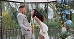 Wedding, fun dance and happy couple in garden with love, celebration and excited for future together. Gazebo, man and woman at marriage reception with flowers, music and happiness at party in nature.