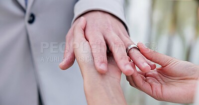 Couple, holding hands and ring for marriage, wedding or ceremony for commitment, love or support. Closeup of people getting married, vows or accessory for symbol of bond, relationship or partnership
