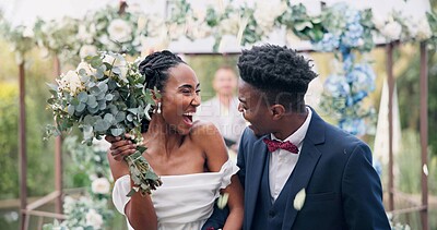 Couple, flower confetti and outdoor wedding with event, walk and happy laugh in nature. Black woman, man and excited for marriage, floral bouquet or holding hands in park, party or together in aisle