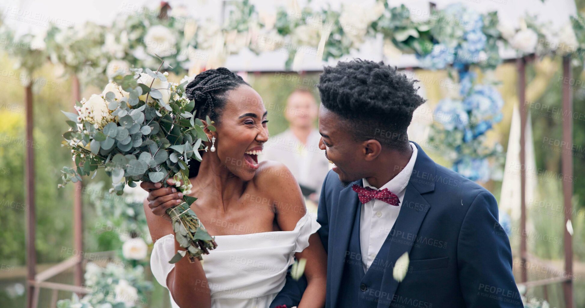 Buy stock photo Couple, flower confetti and outdoor wedding with event, walk and happy laugh in nature. Black woman, man and excited for marriage, floral bouquet or holding hands in park, party or together in aisle