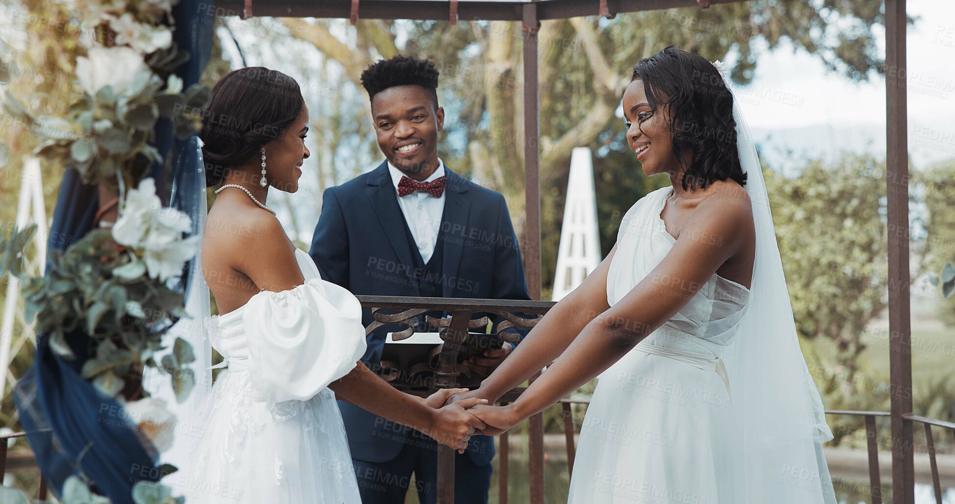 Buy stock photo Women, lesbian wedding and celebration outdoor with priest for love, ceremony and together for commitment. Gay marriage, event and party with bride, black man and African lgbtq couple in garden