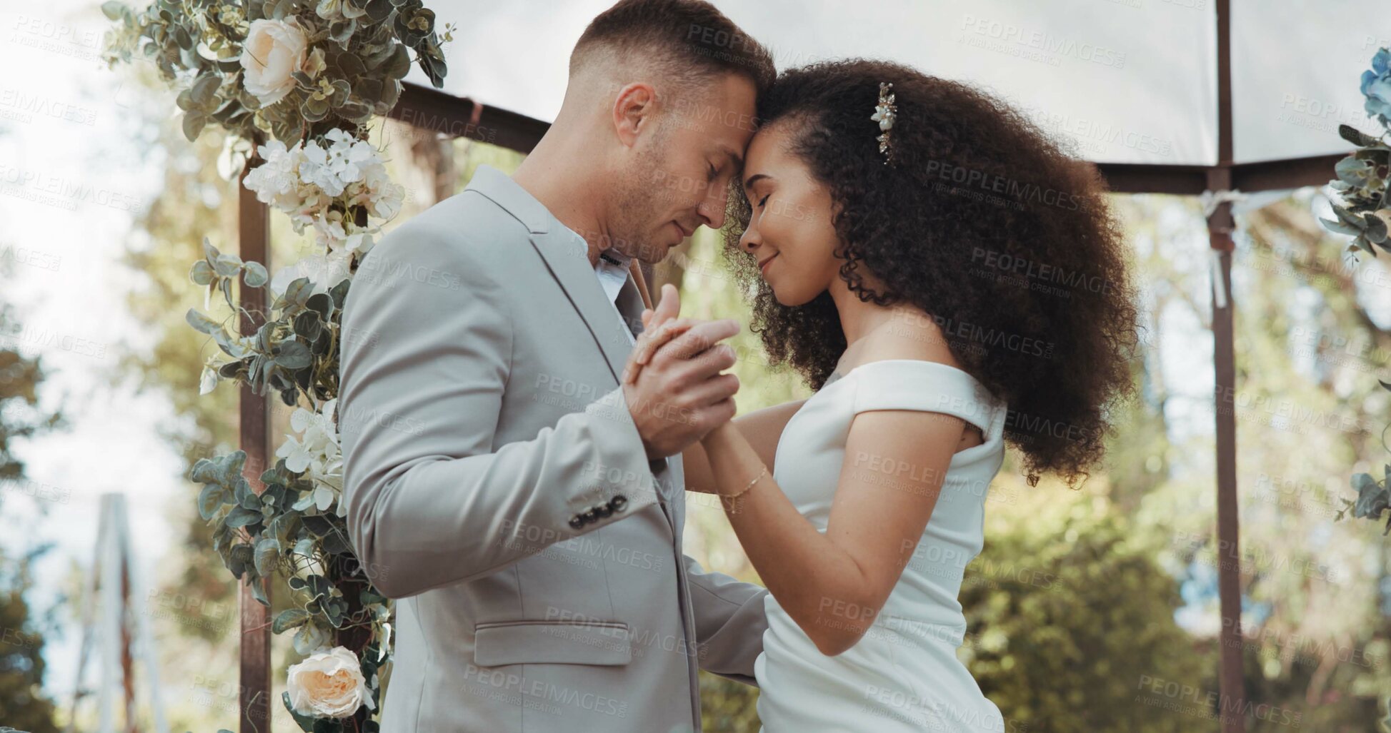 Buy stock photo Couple, wedding and dancing with touch, outdoor and commitment in celebration, love and smile. Interracial marriage, fashion and happy in nature, peace and romance of union and trust