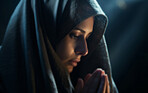 Close up face of middle eastern woman praying in church. Religion concept.