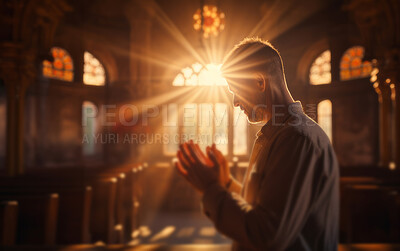 Man praying in church at sunset. Spiritual connection with God. Religion concept.