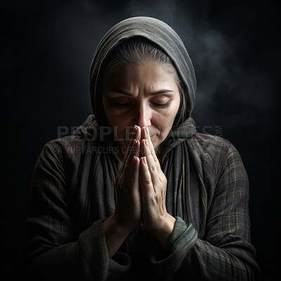 Senior woman in prayer. Hands folded on black backdrop . Religion concept.