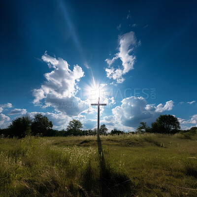 Silhouette of christian cross on a grass field. Sunset, cloudy blue sky. Religion concept.