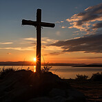 Silhouette of christian cross on a hill. Sunset, golden hour. Religion concept.