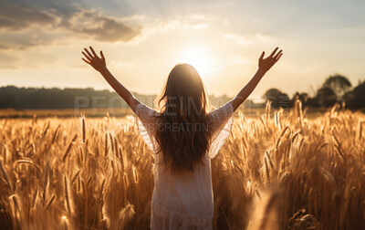 Woman worshiping hands raised to the sunset in open field. Religion concept.
