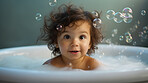 Smiling toddler bathes in bathtub with foam and bubbles. Happy baby bath time