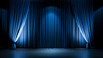 Empty theater stage with blue velvet curtains. Spotlight showtime copy space