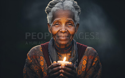 Buy stock photo Senior African American woman praying with candle in hand. Studio backdrop. Religion concept.